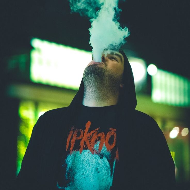 Vape shop Los Angeles customer using a premium vape device at night